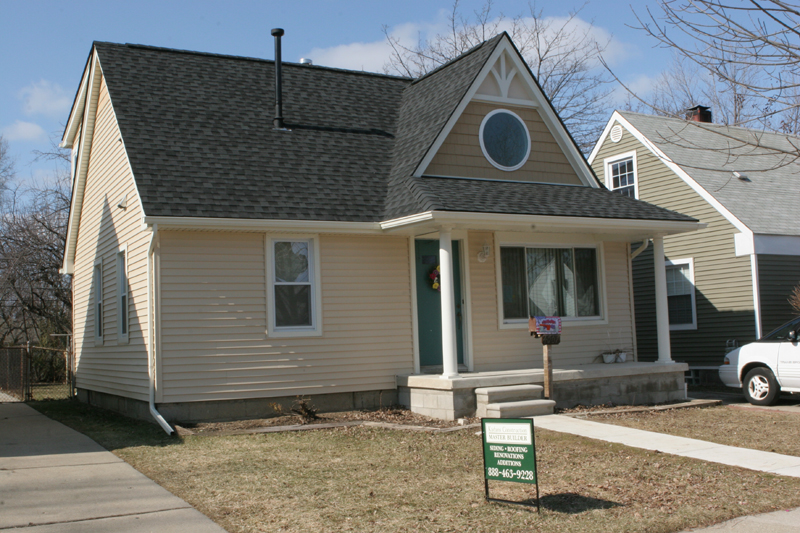 Finished home exterior with new roof and gutters