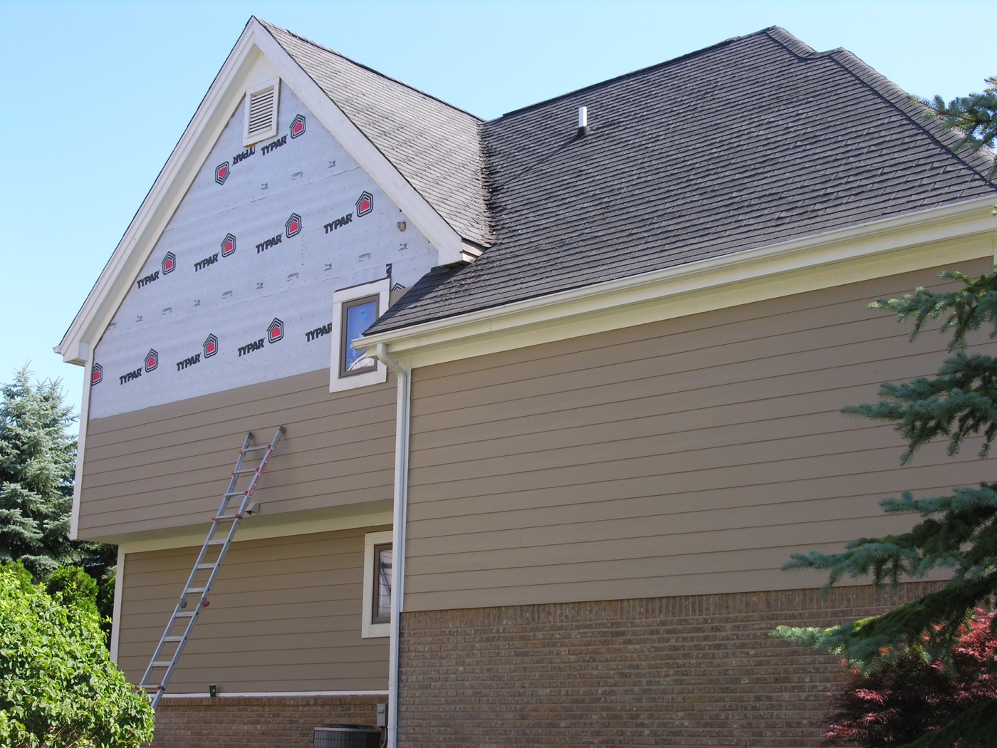 Siding installation showing proper house wrap underneath